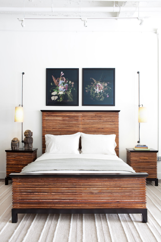 This is an example of an industrial bedroom in Los Angeles with white walls.