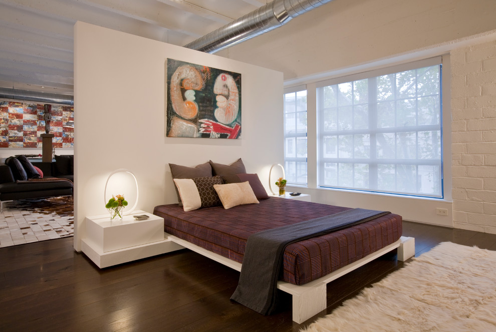 Trendy loft-style dark wood floor bedroom photo in DC Metro with white walls