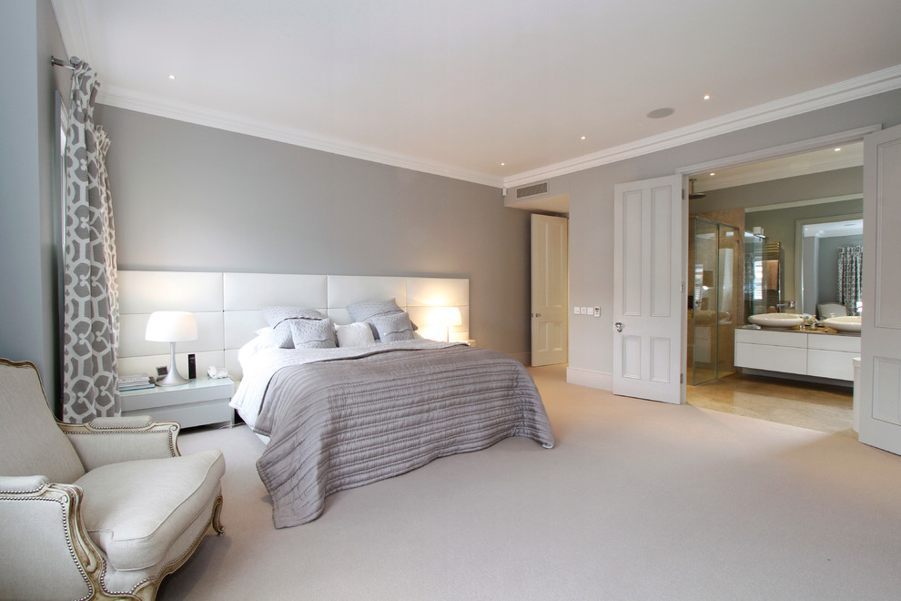 Photo of a large contemporary master bedroom in London with grey walls, carpet and no fireplace.