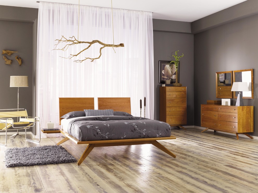 Design ideas for an expansive contemporary master and grey and brown bedroom in New York with grey walls, no fireplace, light hardwood flooring and brown floors.