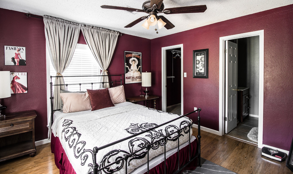 Inspiration for an eclectic master medium tone wood floor bedroom remodel in Austin with red walls and no fireplace