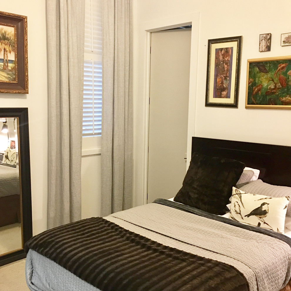 Photo of a small traditional guest bedroom in New Orleans with white walls, carpet and grey floors.