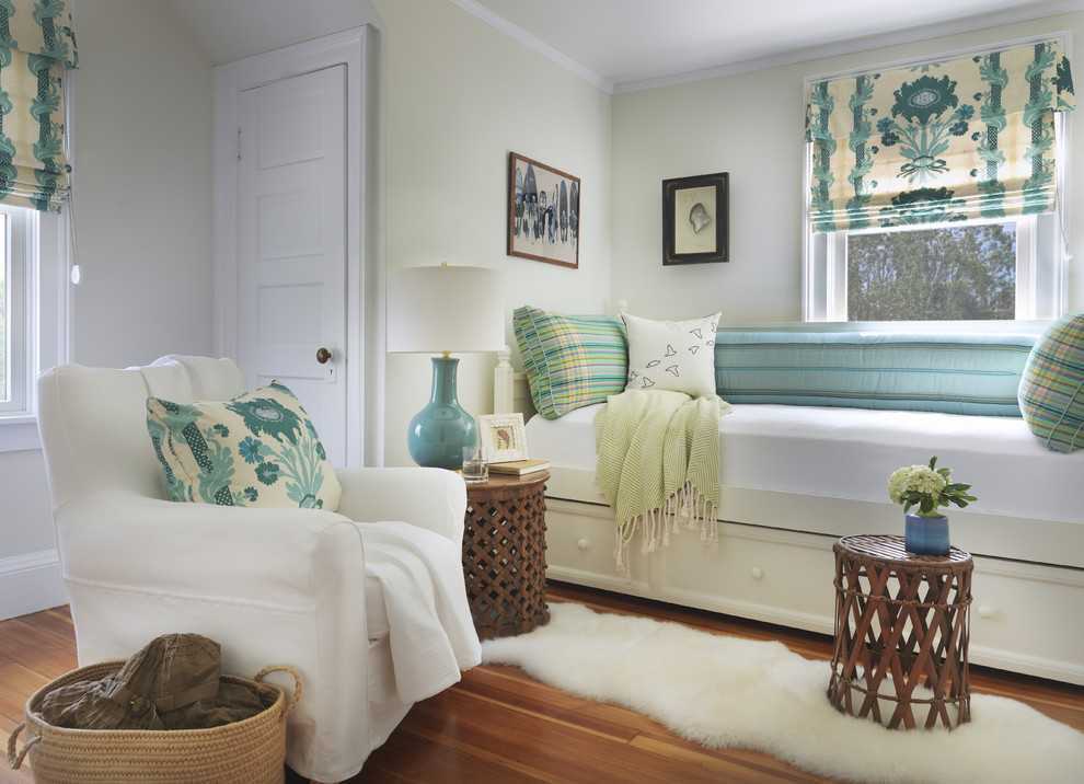 Design ideas for a coastal guest bedroom in Providence with green walls, medium hardwood flooring and feature lighting.