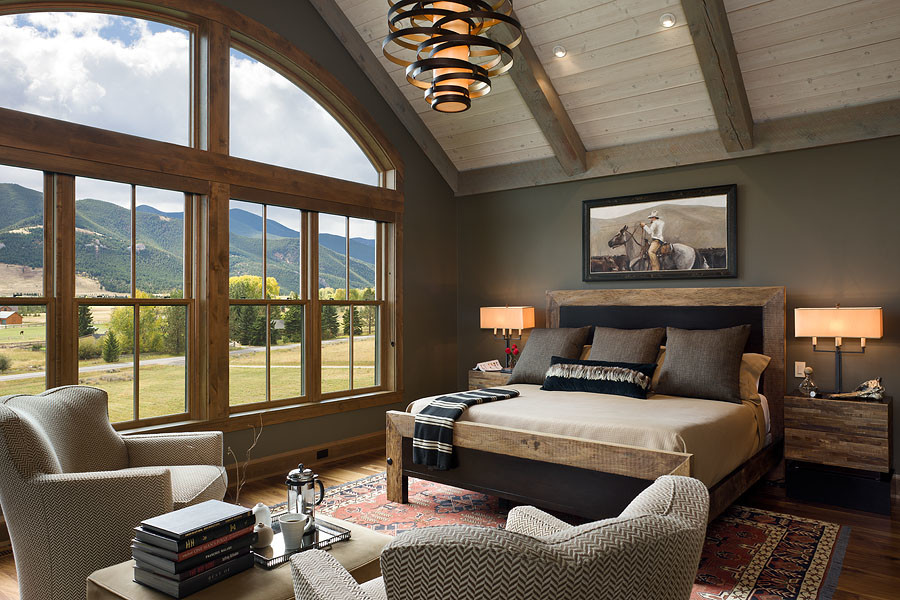Example of a mid-sized mountain style master dark wood floor and brown floor bedroom design in Other with gray walls and no fireplace