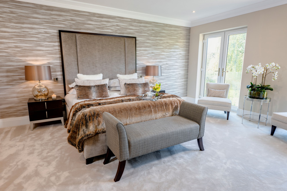 This is an example of a large contemporary master bedroom in Buckinghamshire with grey walls and carpet.