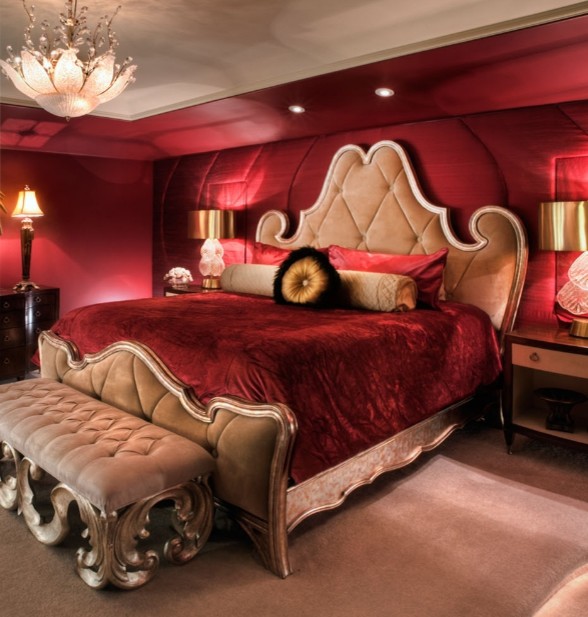 This is an example of a large eclectic master bedroom in New York with red walls, carpet and no fireplace.