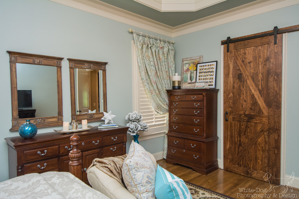 Design ideas for a medium sized traditional master bedroom in Birmingham with blue walls and dark hardwood flooring.