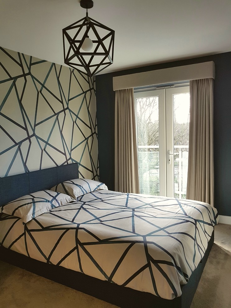 Design ideas for a small modern master bedroom in Hertfordshire with blue walls, carpet and beige floors.
