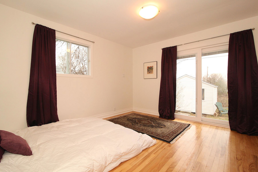 Small master light wood floor bedroom photo in Ottawa with white walls