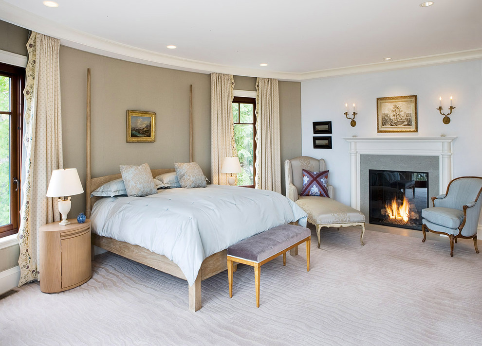 Cette photo montre une chambre tendance de taille moyenne avec un mur beige, une cheminée standard et un manteau de cheminée en pierre.