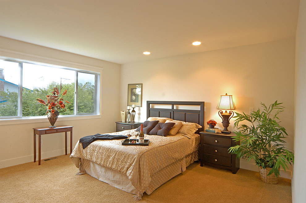 Example of a classic master carpeted bedroom design in Seattle with beige walls