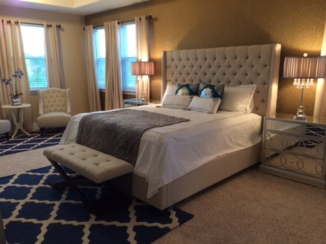 Example of a mid-sized trendy master carpeted bedroom design in Orlando with brown walls and no fireplace