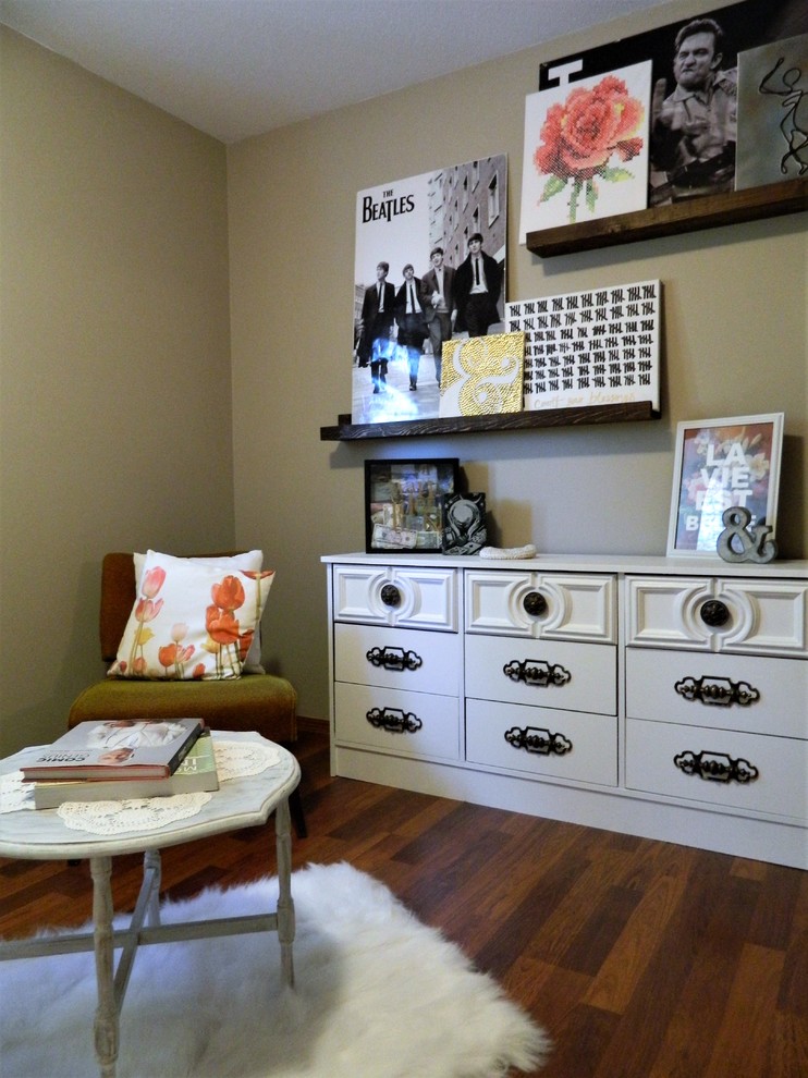 This is an example of a medium sized shabby-chic style guest bedroom in Calgary with beige walls and laminate floors.