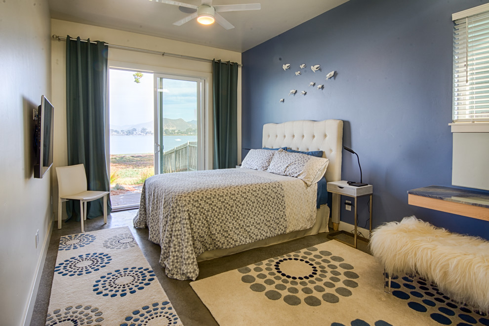 Medium sized contemporary master bedroom in San Luis Obispo with blue walls, concrete flooring and no fireplace.