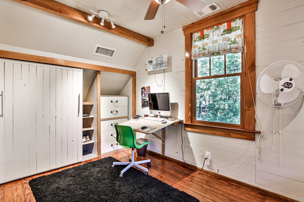 Example of a small cottage loft-style medium tone wood floor, shiplap ceiling and shiplap wall bedroom design with gray walls