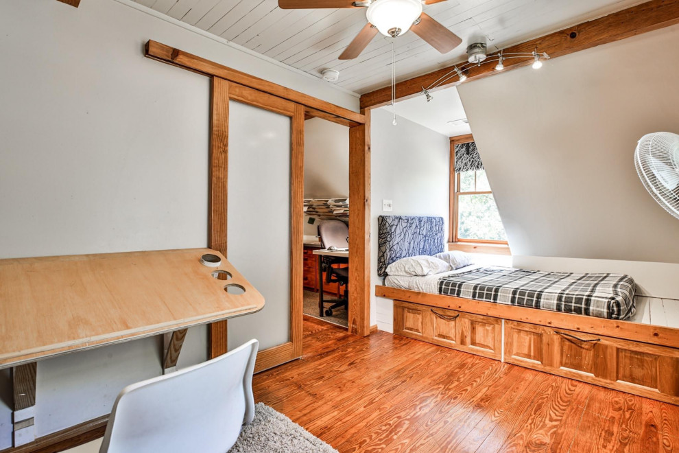 Ispirazione per una piccola camera da letto stile loft country con pareti grigie, pavimento in legno massello medio, soffitto in perlinato e pareti in perlinato