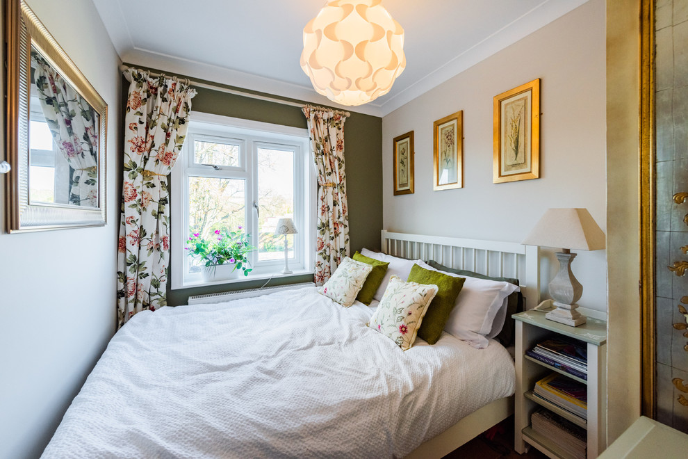 This is an example of a farmhouse bedroom in London with beige walls.