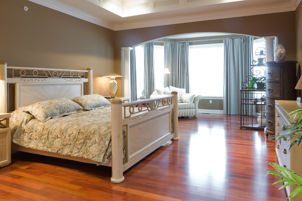 This is an example of a classic master bedroom in Philadelphia with beige walls and medium hardwood flooring.