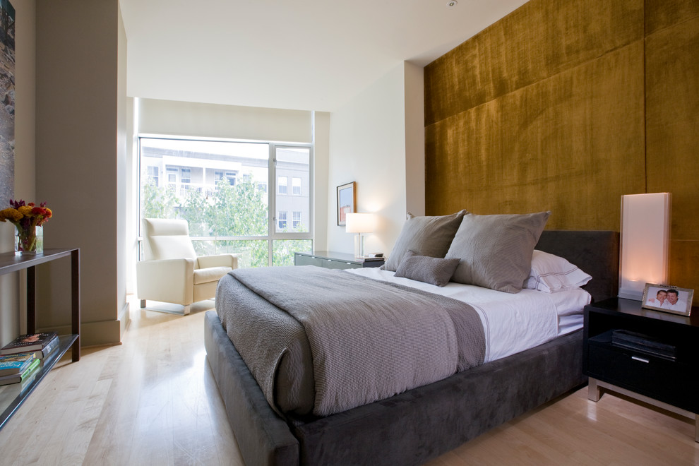 This is an example of a contemporary grey and brown bedroom in DC Metro with brown walls and light hardwood flooring.