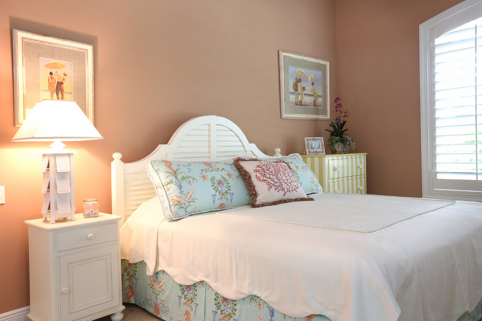 Inspiration for a mid-sized tropical guest carpeted bedroom remodel in Orlando with orange walls