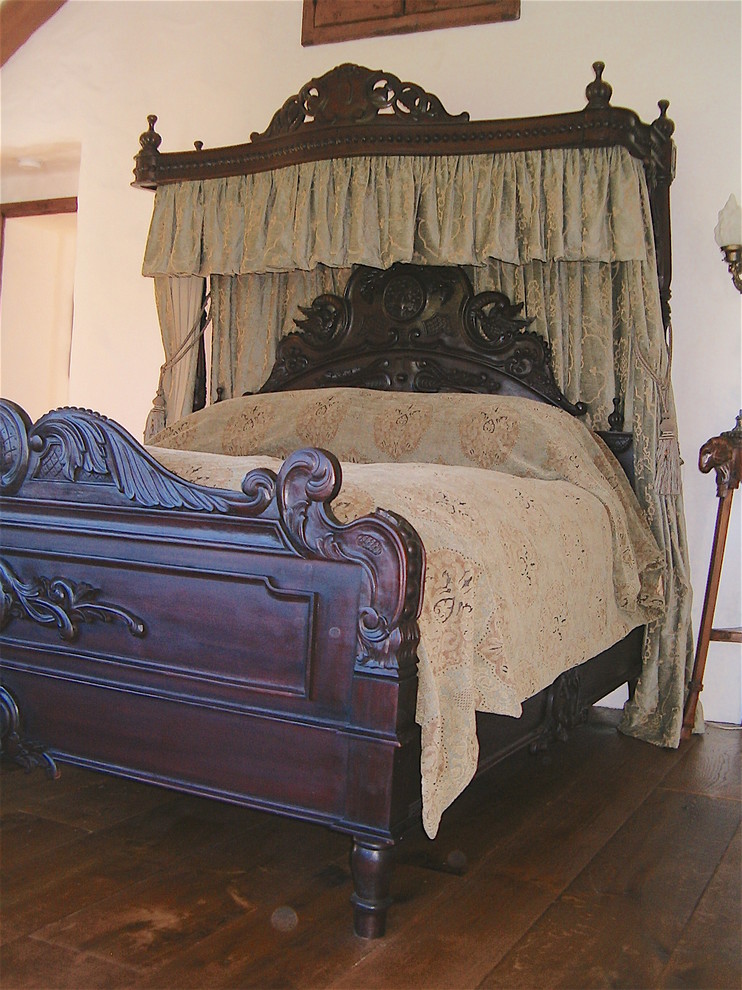 Photo of a large victorian guest bedroom in Other with white walls, dark hardwood flooring and brown floors.
