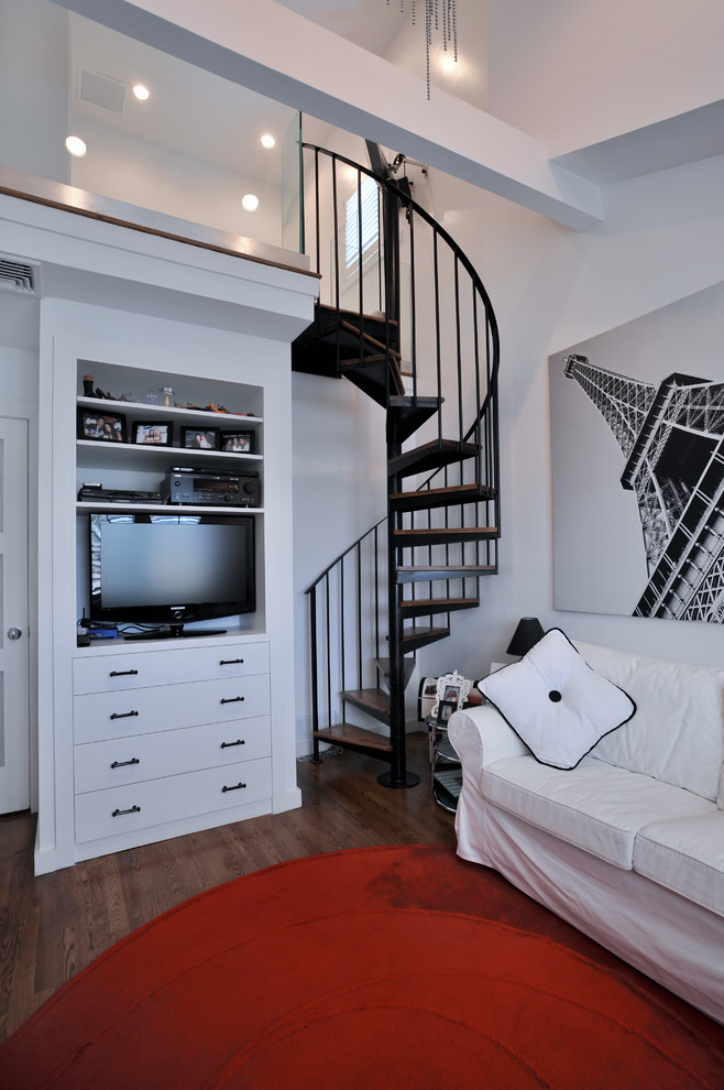 Small contemporary mezzanine bedroom in New York with white walls and dark hardwood flooring.