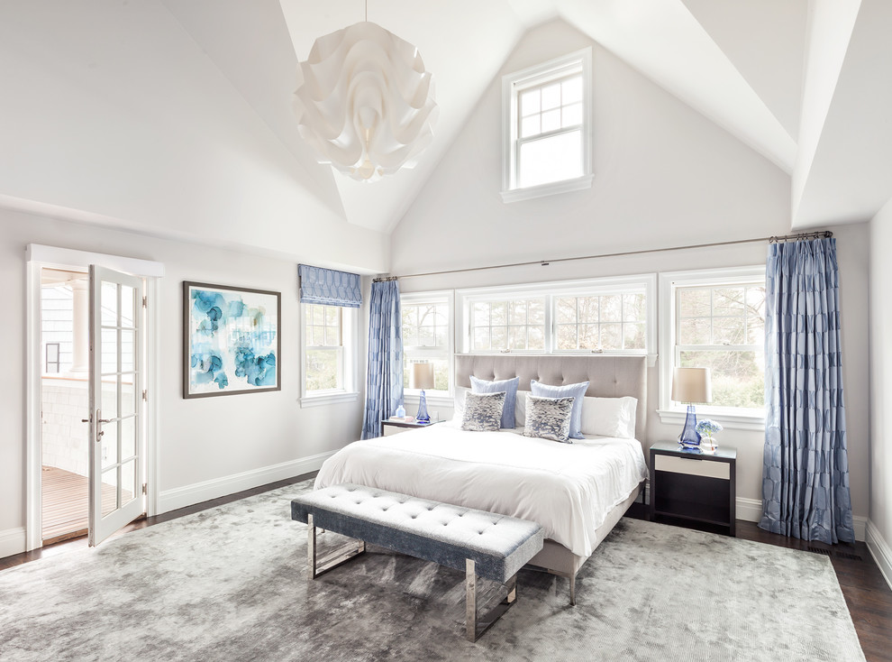 Пример оригинального дизайна: спальня в стиле неоклассика (современная классика) с серыми стенами, темным паркетным полом, коричневым полом и синими шторами