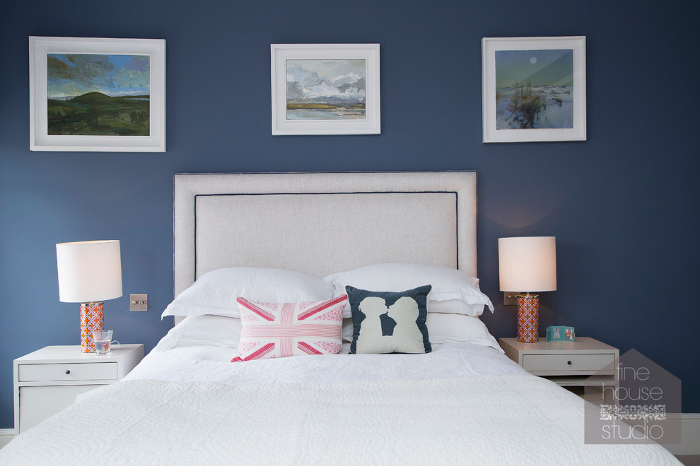 Photo of a large eclectic master bedroom in Gloucestershire with blue walls and carpet.