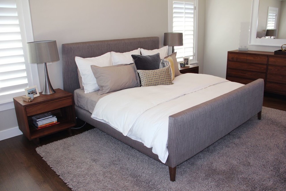 Example of a large transitional master dark wood floor and brown floor bedroom design in Denver with gray walls and no fireplace