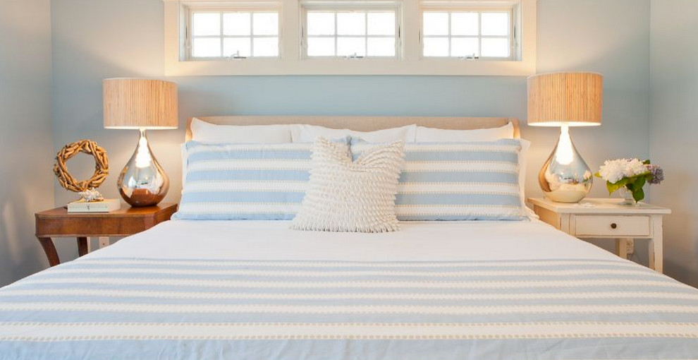 Example of a mid-sized beach style guest light wood floor bedroom design in Boston with blue walls and no fireplace