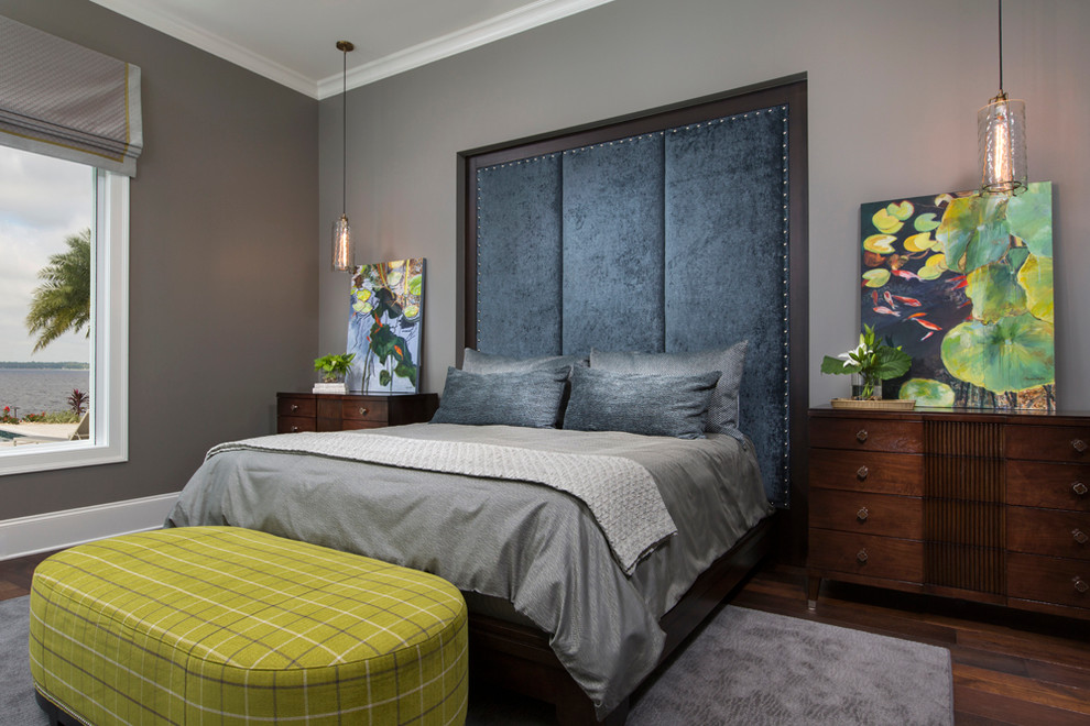 Example of a transitional master medium tone wood floor bedroom design in Jacksonville with gray walls