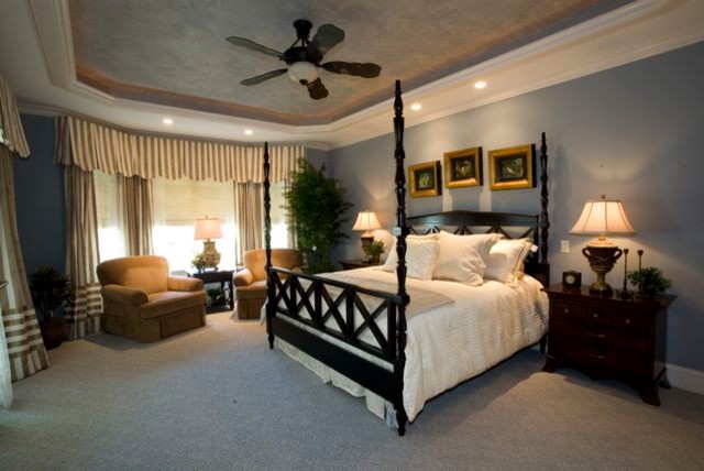 Large classic master bedroom in Cincinnati with blue walls and carpet.