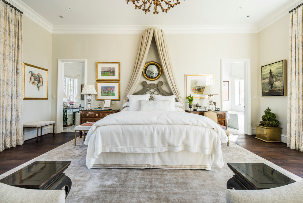 This is an example of a traditional bedroom in Atlanta with beige walls and dark hardwood flooring.