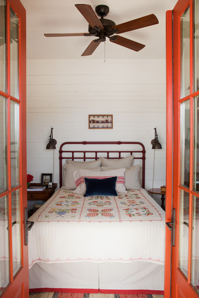 Example of a farmhouse bedroom design in Atlanta with white walls
