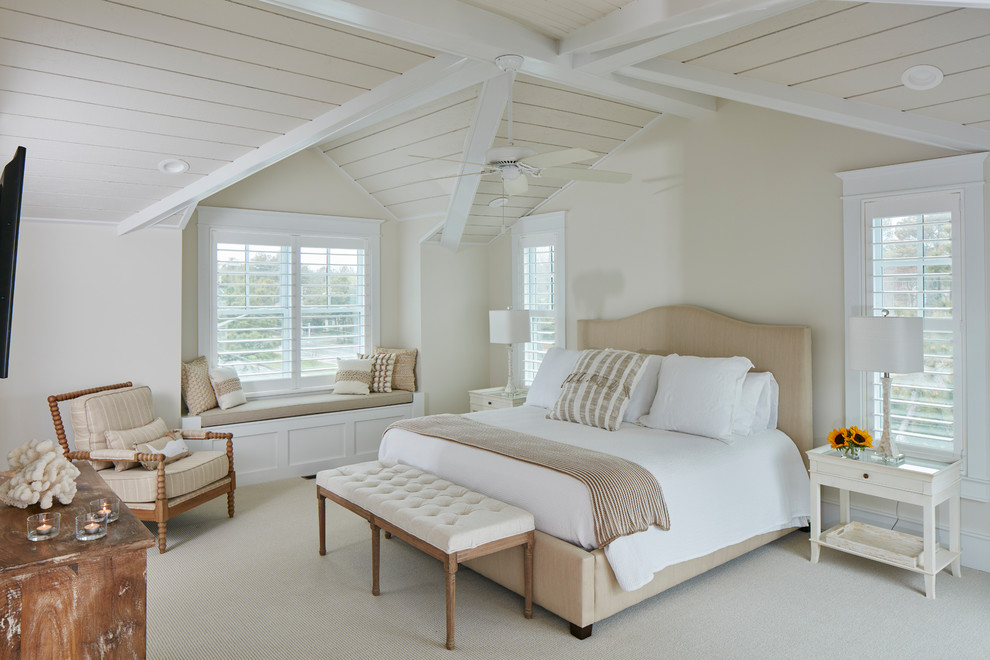 Design ideas for a large beach style master bedroom in Other with beige walls, carpet and beige floors.