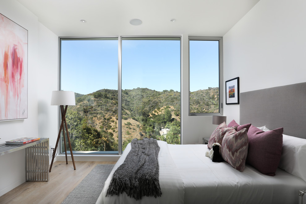 Bedroom - contemporary light wood floor and beige floor bedroom idea in Los Angeles with white walls