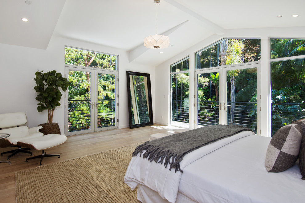 Inspiration for a classic bedroom in Los Angeles with white walls and light hardwood flooring.