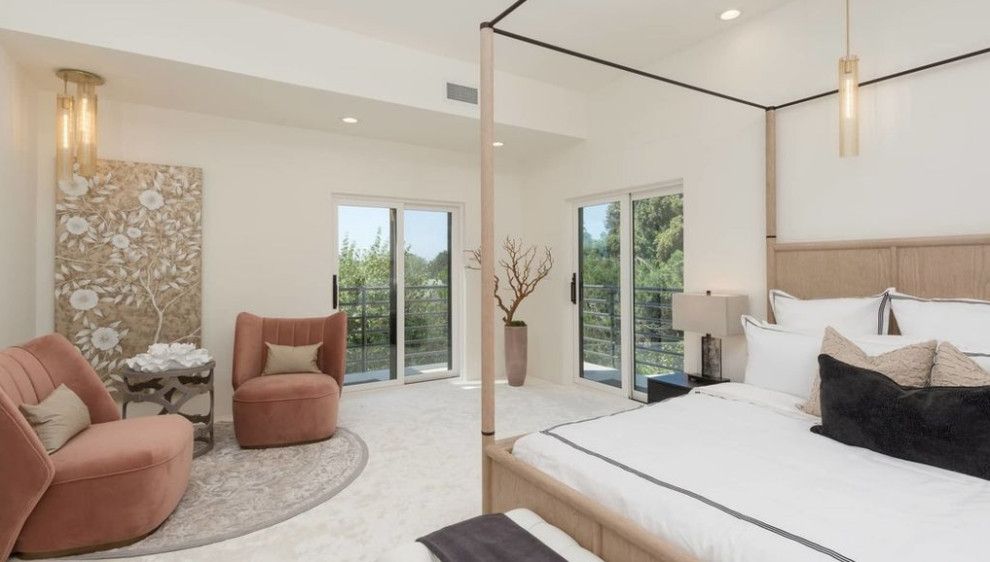 This is an example of a large classic master bedroom in Los Angeles with white walls, carpet, no fireplace and white floors.