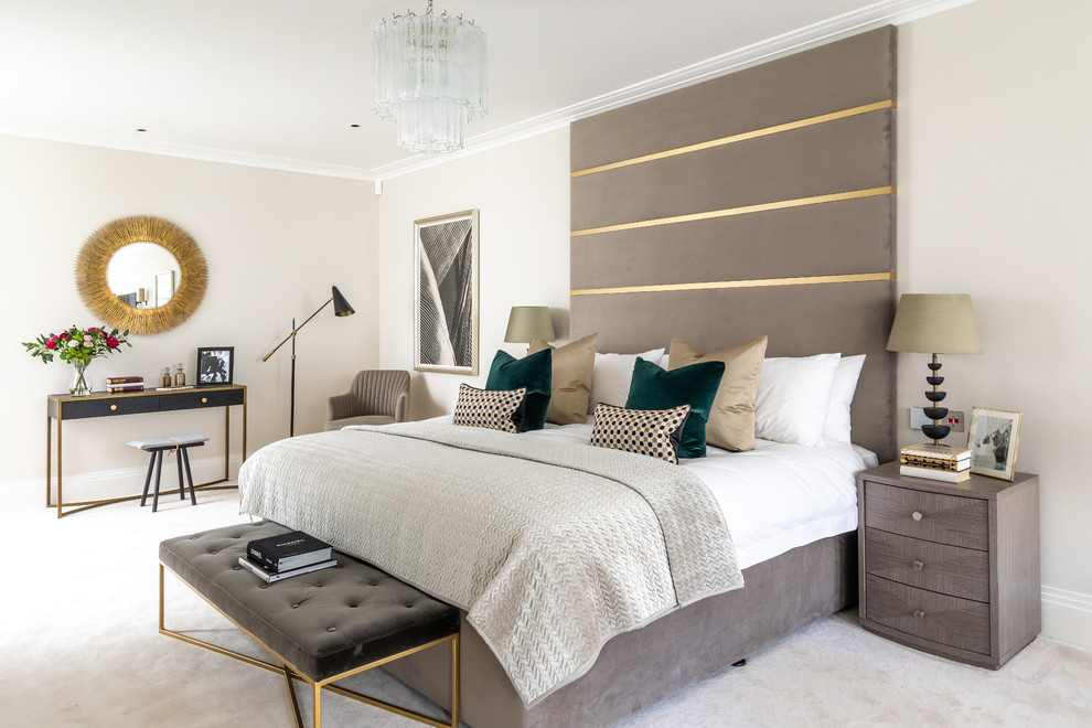 Design ideas for a contemporary master bedroom in London with beige walls, carpet, beige floors and feature lighting.