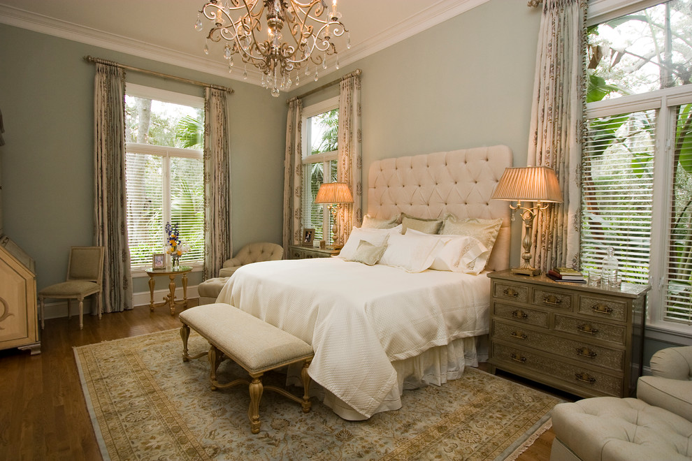 This is an example of a medium sized traditional master bedroom in Tampa with green walls, dark hardwood flooring, no fireplace and brown floors.