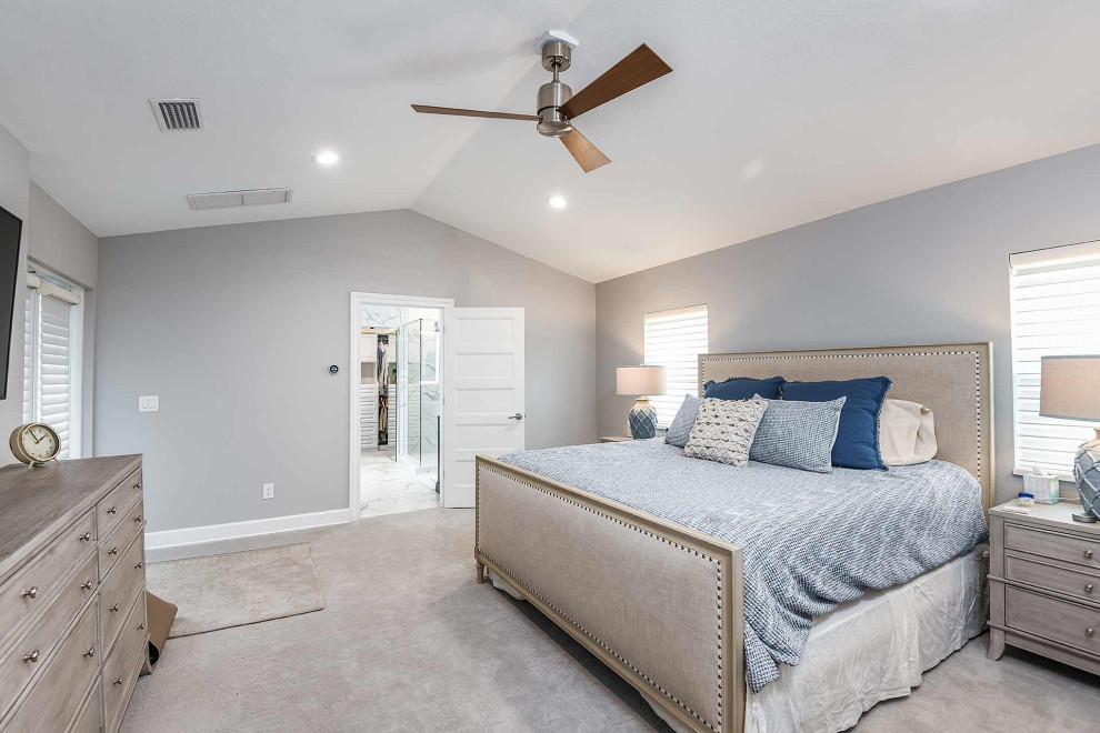 This is an example of a medium sized nautical master bedroom in Tampa with grey walls, carpet, grey floors and a vaulted ceiling.