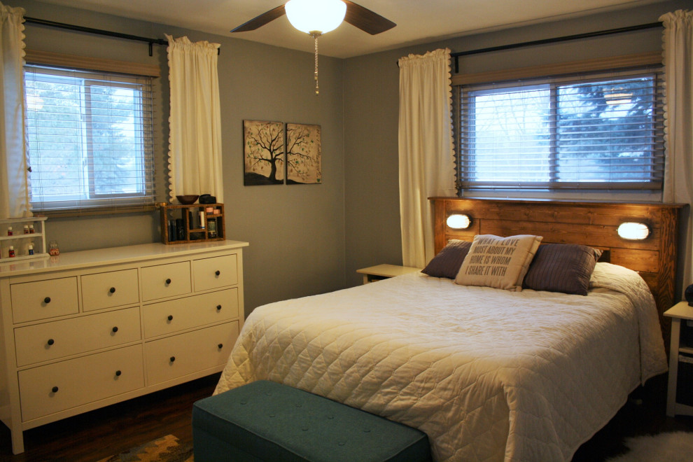 This is an example of a medium sized rural master bedroom in Other with blue walls, laminate floors and brown floors.