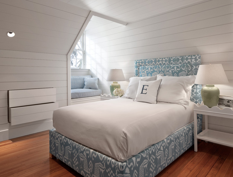 Example of a beach style medium tone wood floor bedroom design in Providence with white walls