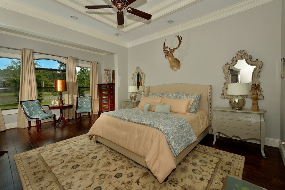 Medium sized classic master bedroom in Houston with blue walls and dark hardwood flooring.