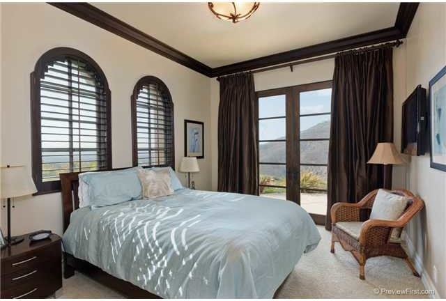 Inspiration for a small mediterranean guest carpeted bedroom remodel in San Diego with brown walls and no fireplace