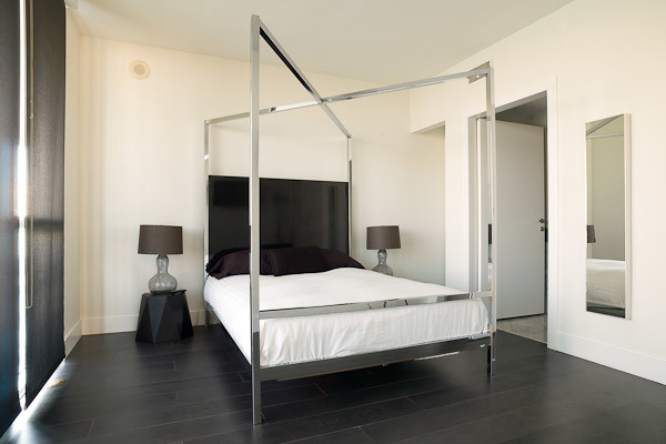 Пример оригинального дизайна: хозяйская спальня среднего размера в современном стиле с белыми стенами и темным паркетным полом