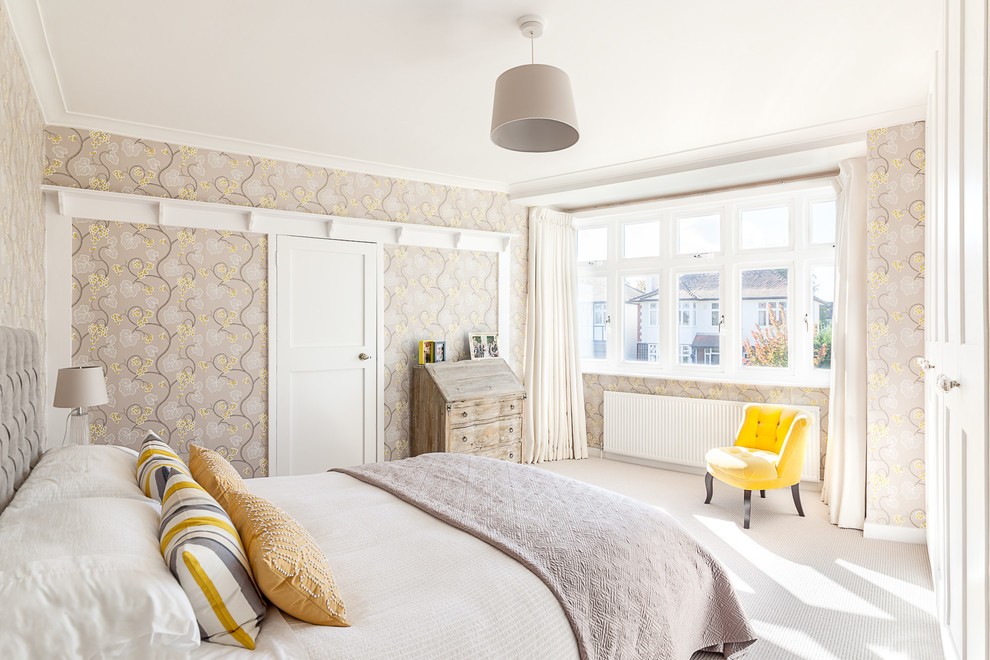 Medium sized traditional master and grey and yellow bedroom in London with carpet and grey walls.