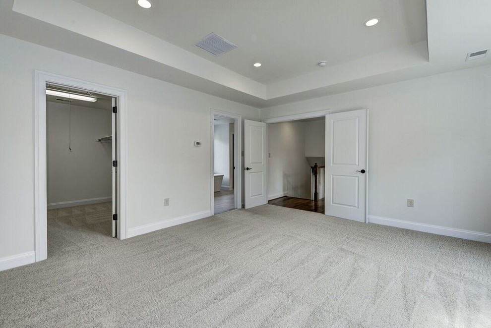 Mid-sized transitional master carpeted bedroom photo in DC Metro with white walls