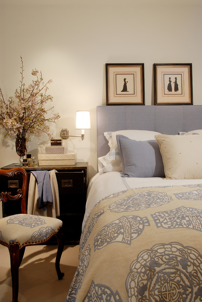 This is an example of a traditional master bedroom in Los Angeles with beige walls.
