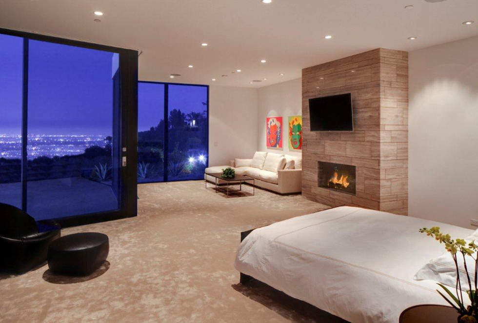 Idées déco pour une chambre moderne de taille moyenne avec un mur blanc, une cheminée standard, un manteau de cheminée en carrelage et un sol beige.